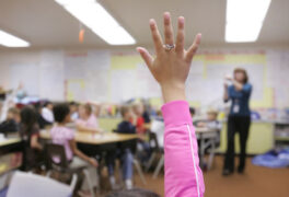 Raised hand in classroom