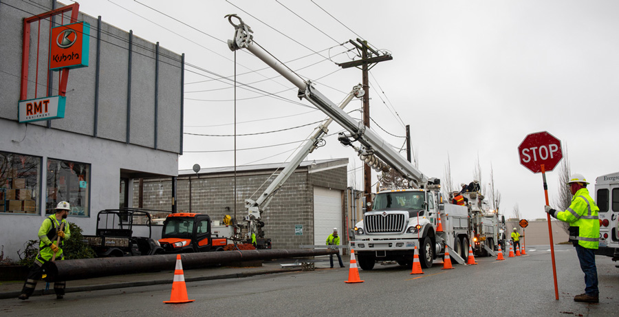 Line crews replacing pole