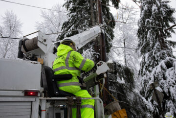 Crew member working to install power pole