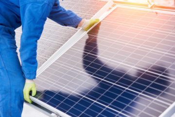 Men building solar panel image