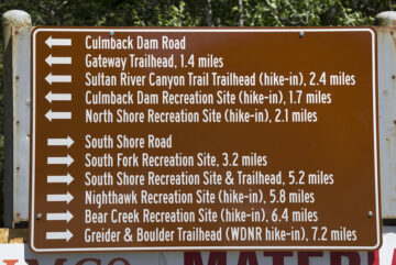 A sign shows the many hiking opportunities around Spada Lake