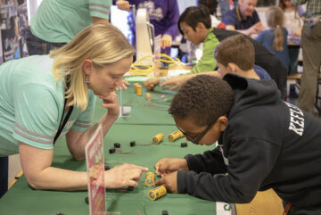 Heather helps student at STEM night