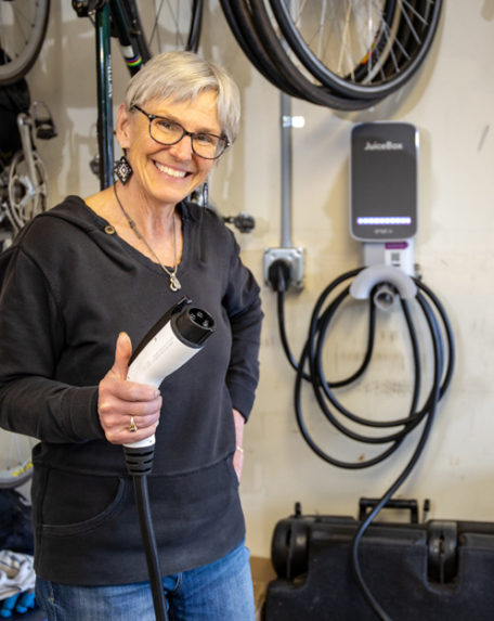 FlexEnergy customer holding EV charger