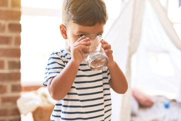 young boy drinking water