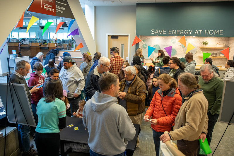 Customers discuss energy efficiency at booths inside the EB.