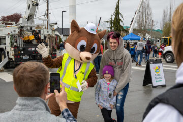 Mom and son smiling with mascot