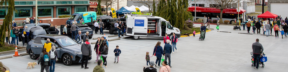 An EV car show, food truck and electric bus in front of PUD headquarters