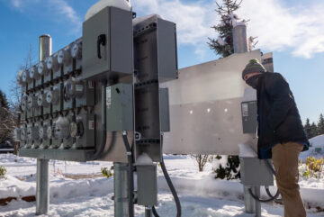 A technician looks at a bank of advanced meters