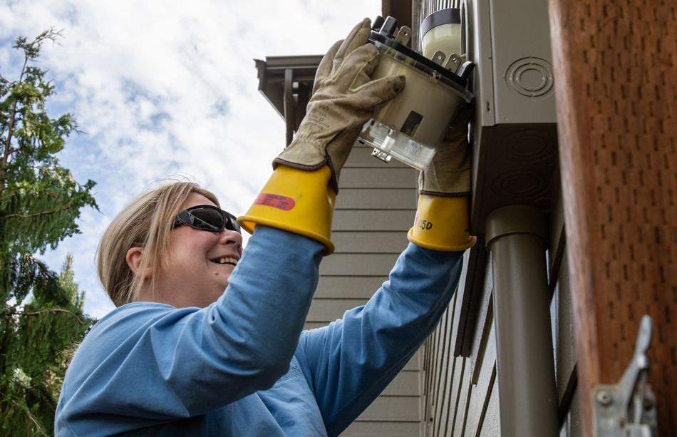 A meter professional installs an advanced electric meter