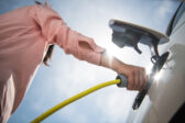 Woman charging electric vehicle