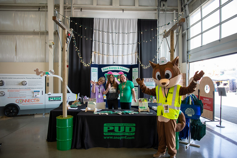 Zip working the fair booth with two PUD employees and Commissioner Toni Olson