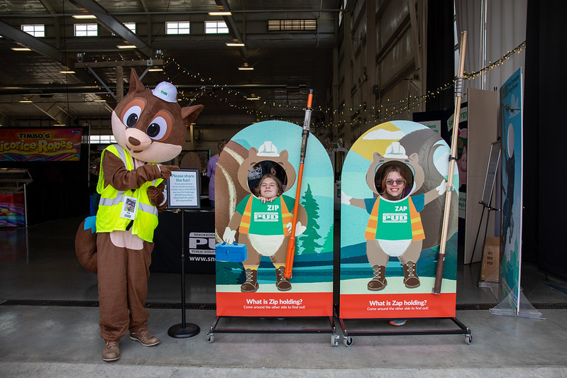 Customers enjoy photo display next to squirrel mascot