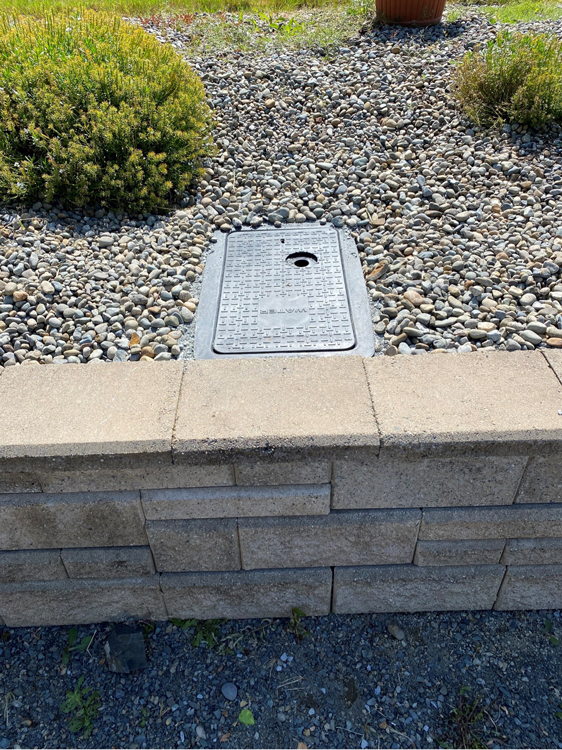 Meter box is shown repositioned against retaining wall 