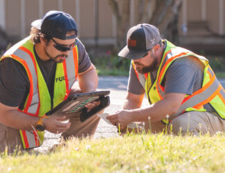 Two professional water workers putting in advanced meter