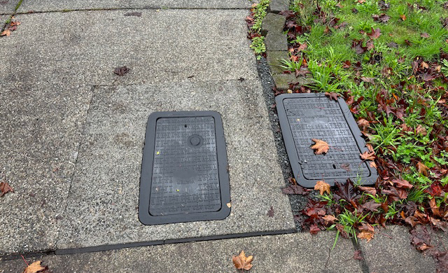 Meter box is shown in driveway with permanent patch installed.
