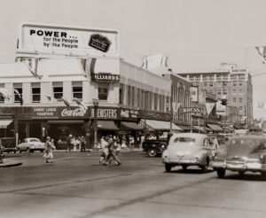 A bustling Everett street corner during a business day from the thirties or forties.