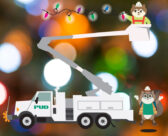 Zip and Zap hanging holiday lights from a PUD line truck