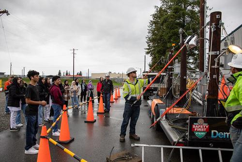 A group of high school students watches an Arc trailer safety demonstration