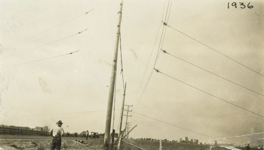 Workers repairing a downed power line in 1936