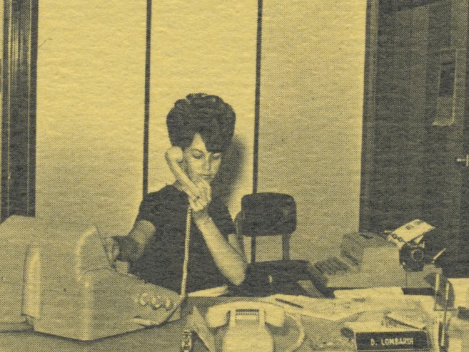 Receptionist with 1960s beehive hairdo answers calls at the PUD Lynnwood office in 1968. 