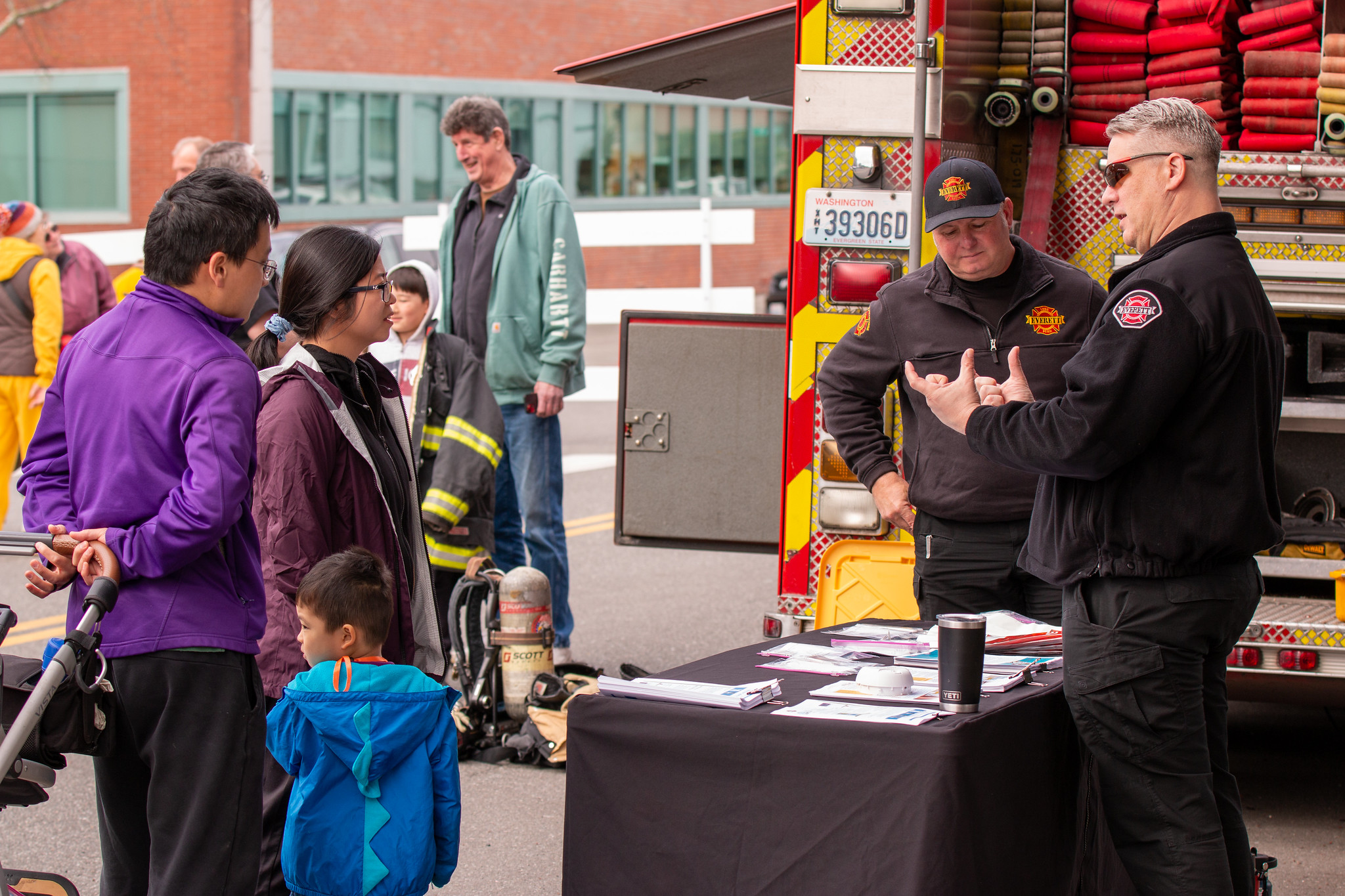 People chatting at Energy Block Party with fire truck in background