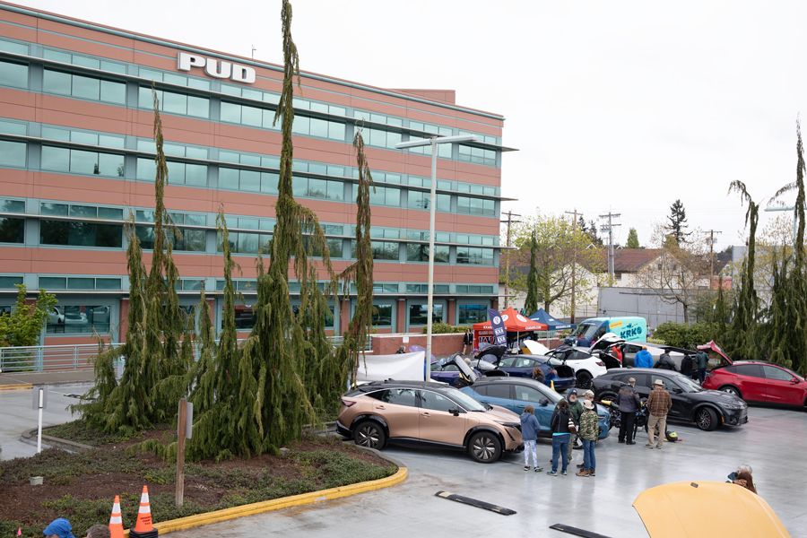 The front of the PUD building in Everett with the front lot filled with electric vehicles for a car show