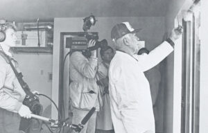 An energy technician uses smoke to show a TV news crew the lack of air infiltration in a Good Sense Home. 