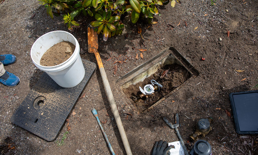 A brand new water meter nests in a meter box
