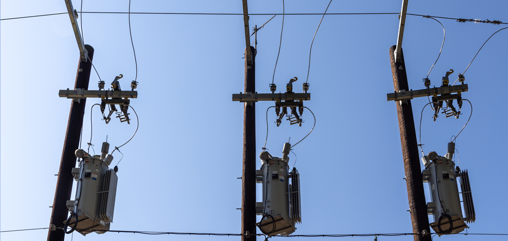 Voltage regulators and disconnect switches on three poles