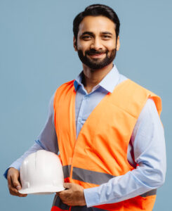 Man holding hardhat and smiling at camera studio photo