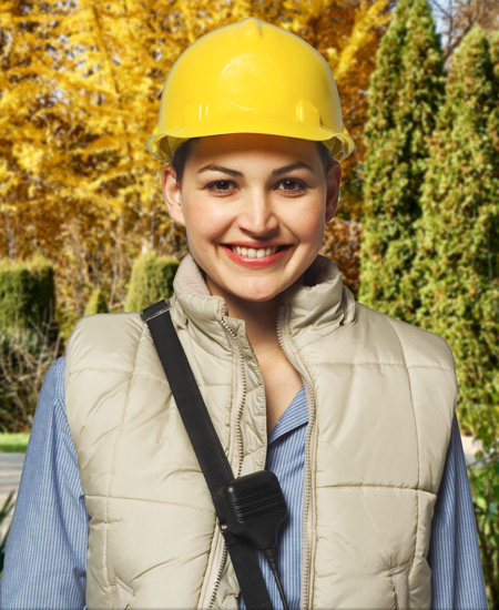 Young woman in hardhard smiling outdoors